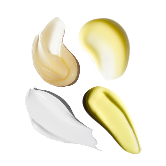 Four swatches of different colored creams on a white background