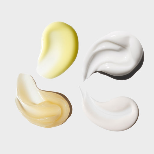 Three swatches of different colored creams on a light gray background