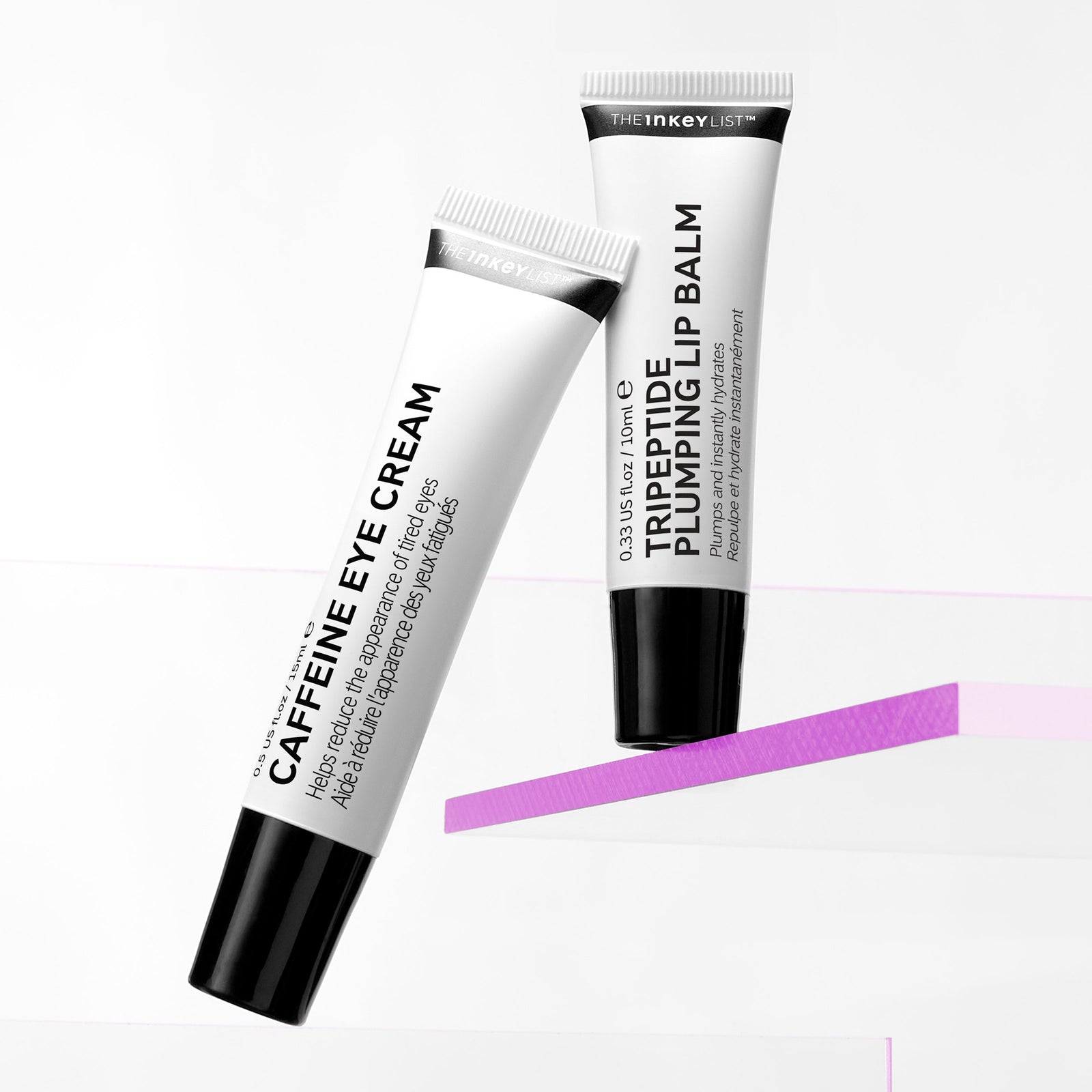 Light shot of Eye & Lip Hydration Duo including Tripeptide Lip Treatment and Caffeine Eye Cream on a purplr shelf with white background