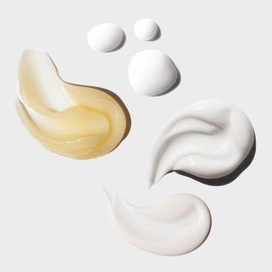 Skincare cream swatches on a light gray background