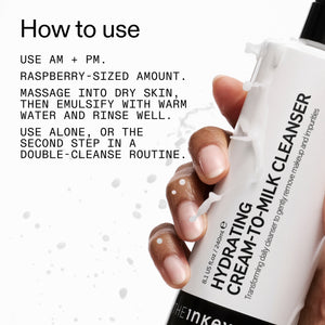 Hand holding Milk Cleanser with usage instructions on a white background