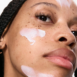 Close-up of a person's face using Dewy Sunscreen SPF 30