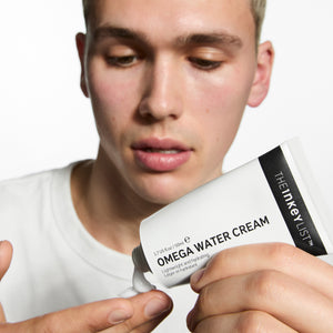 Model applying Omega Water Cream to his hand
