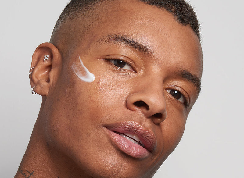 Male model with moisturiser on his cheek