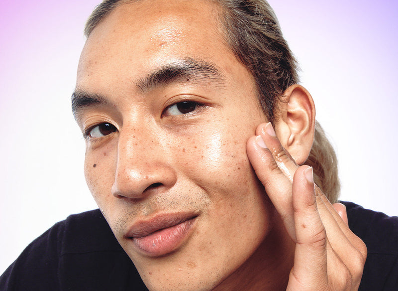 Model rubbing product in his forehead