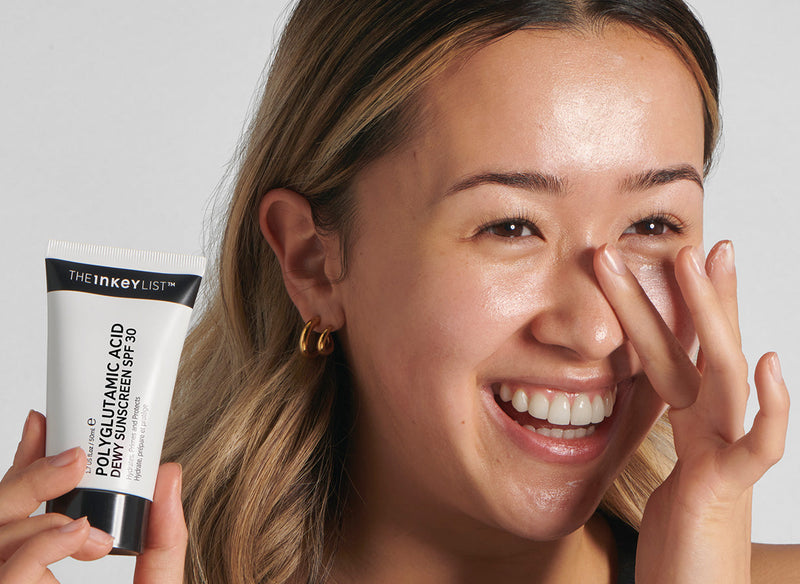 Model applying PGA SPF on her face