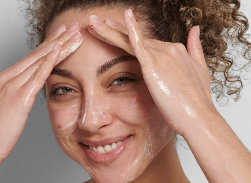 Model washing their face with The INKEY List product