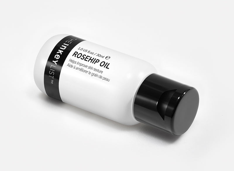 Rosehip oil bottle on white background