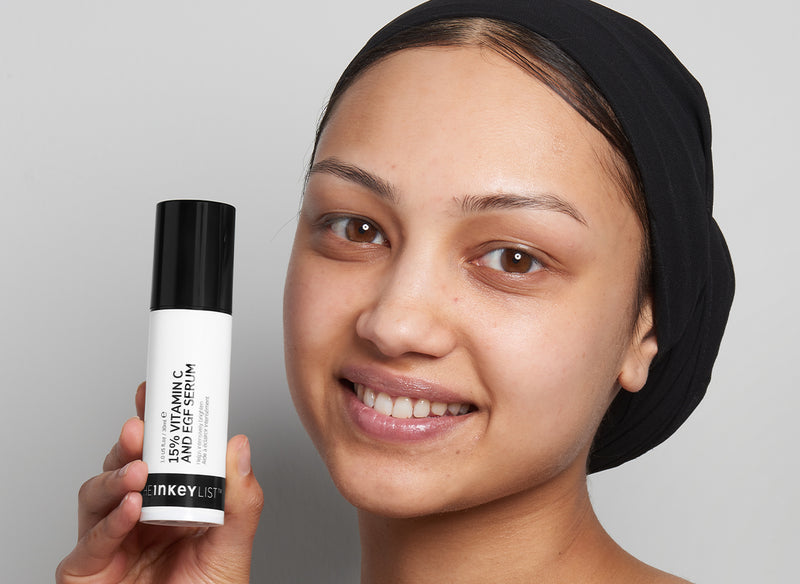 Model holding Vitamin C bottle