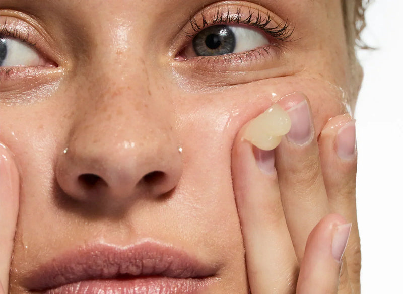 Woman applying skincare