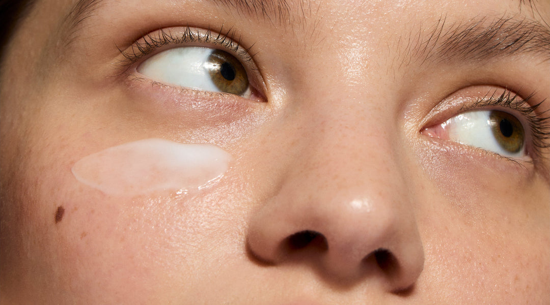 Model applying skincare to face