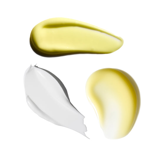 Two swatches of cream, one yellow and one white, on a white background