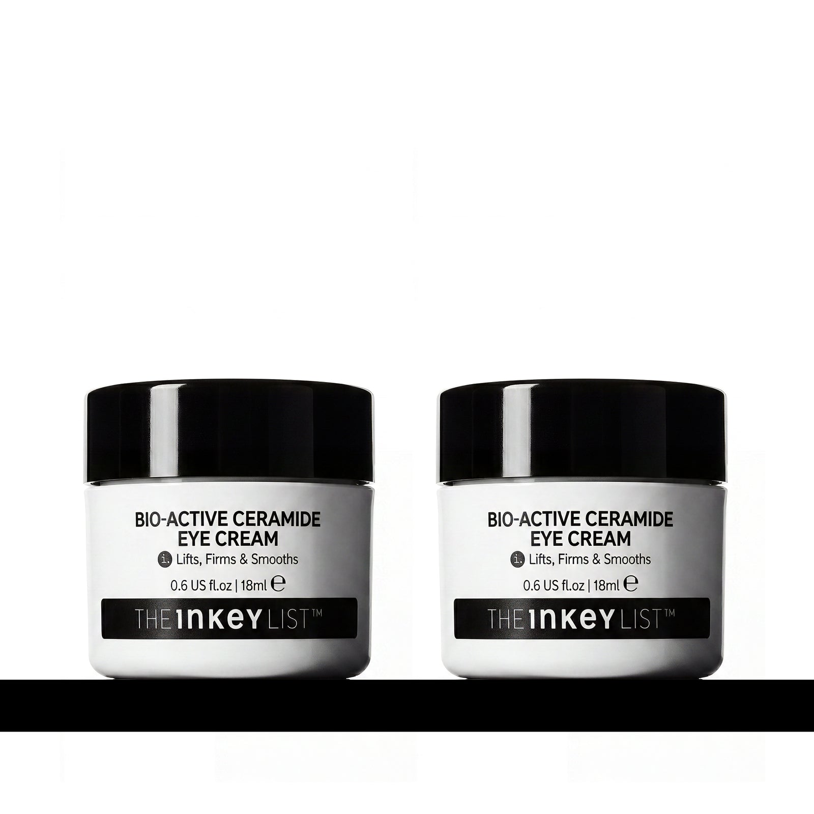 Two white jars of THE INKEY LIST Bio-Active Ceramide Eye Cream with black lids, displayed side-by-side on a white background with a black horizontal line at the bottom.
