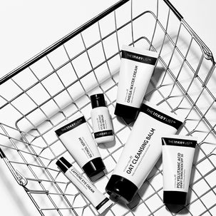 Collection of The INKEY List skincare products in a metal basket on a white background