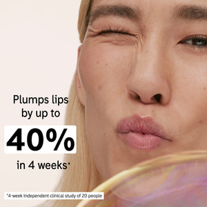 Model holding a tube of Tripeptide Plumping Lip Balm with key claim statistic