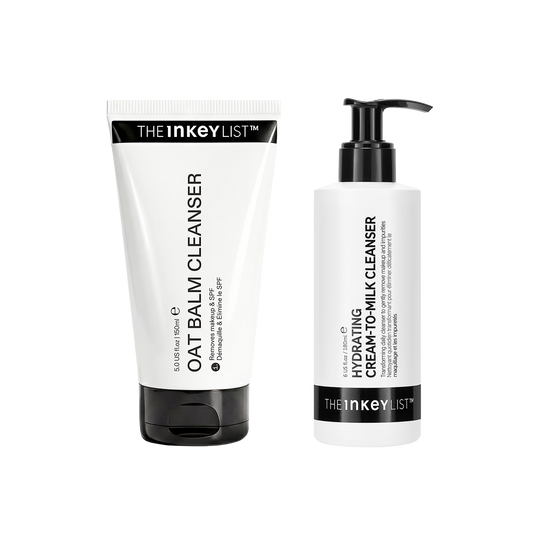 Two skincare products from The Inkey List on a plain white background: a white tube labeled Oat Balm Cleanser with a black cap, and a white pump bottle labeled Hydrating Cream-to-Milk Cleanser with a black pump.