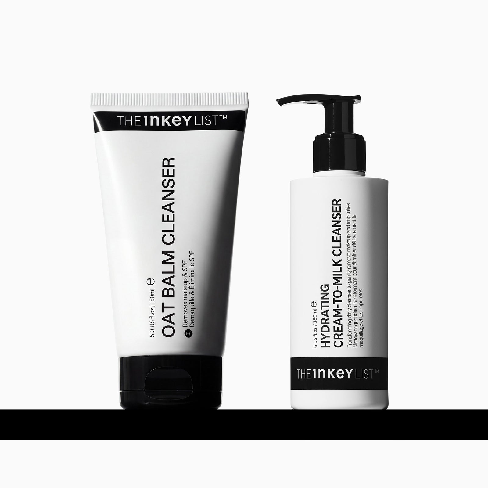 Two skincare products from The Inkey List on a white background with a black horizontal bar at the bottom. On the left is a white squeeze tube labeled 'OAT BALM CLEANSER' with a black cap.