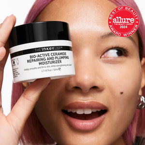 Person holding a skincare product with 'Allure Best of Beauty' award badge