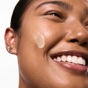 Model with swatch of retinol on skin