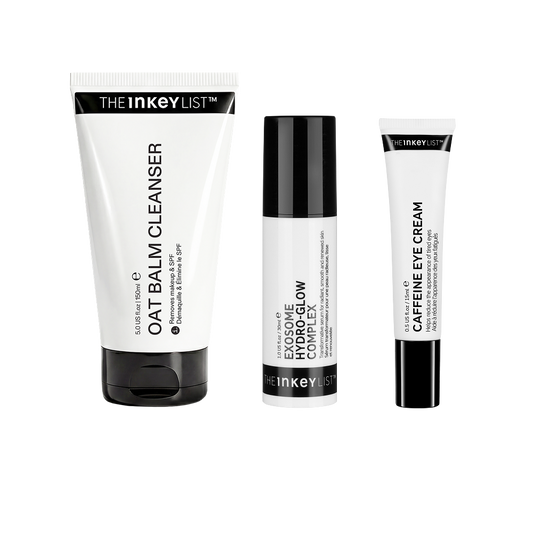 Three skincare products from The Inkey List on a plain white background: a large oat balm cleanser tube, a exosome complex bottle, and a caffeine eye cream tube.