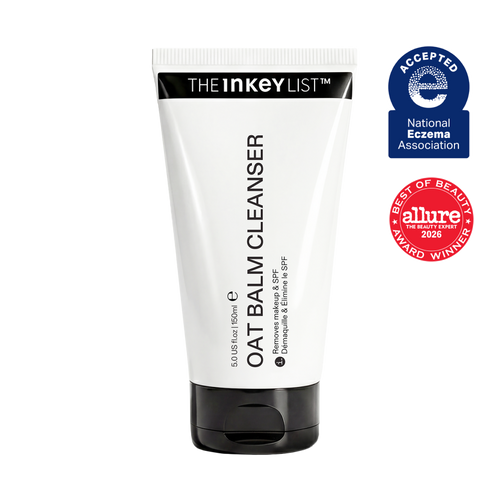 A white tube of The Inkey List Oat Balm Cleanser with a black cap, shown on a plain white background alongside two award badges: a blue National Eczema Association 'Accepted' badge and a red Allure 'Best of Beauty 2026' award badge.