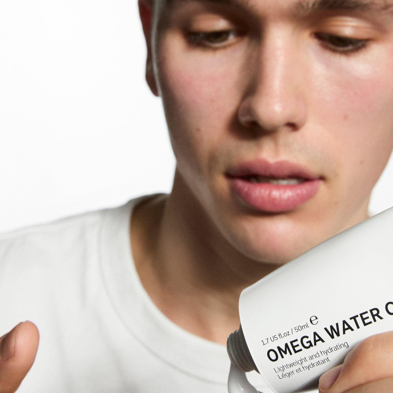 Model applying Omega Water Cream to his hand
