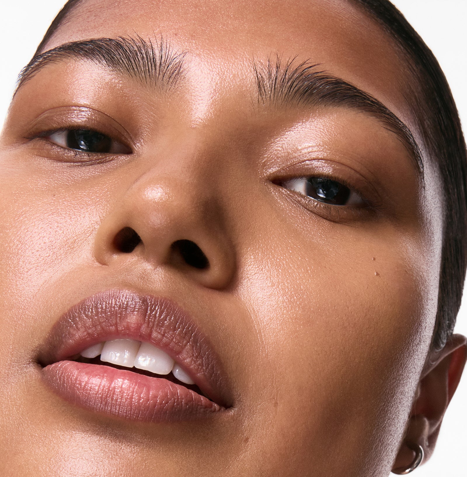 Close-up of a person's face with a neutral background
