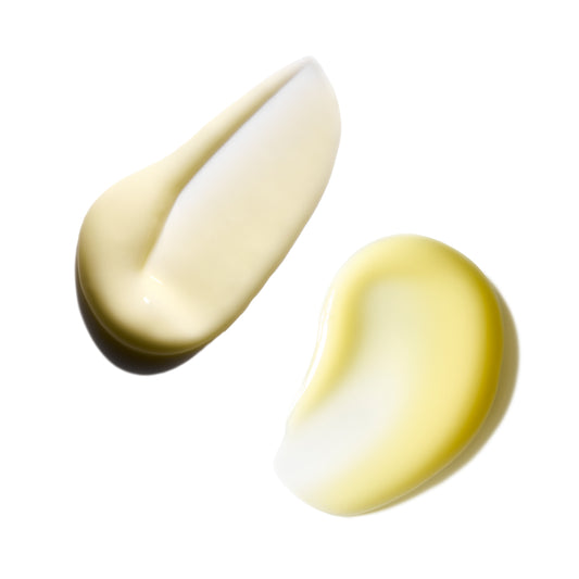 Two droplets of cream on a white background