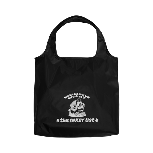 Black tote bag with white text and graphics on a white background
