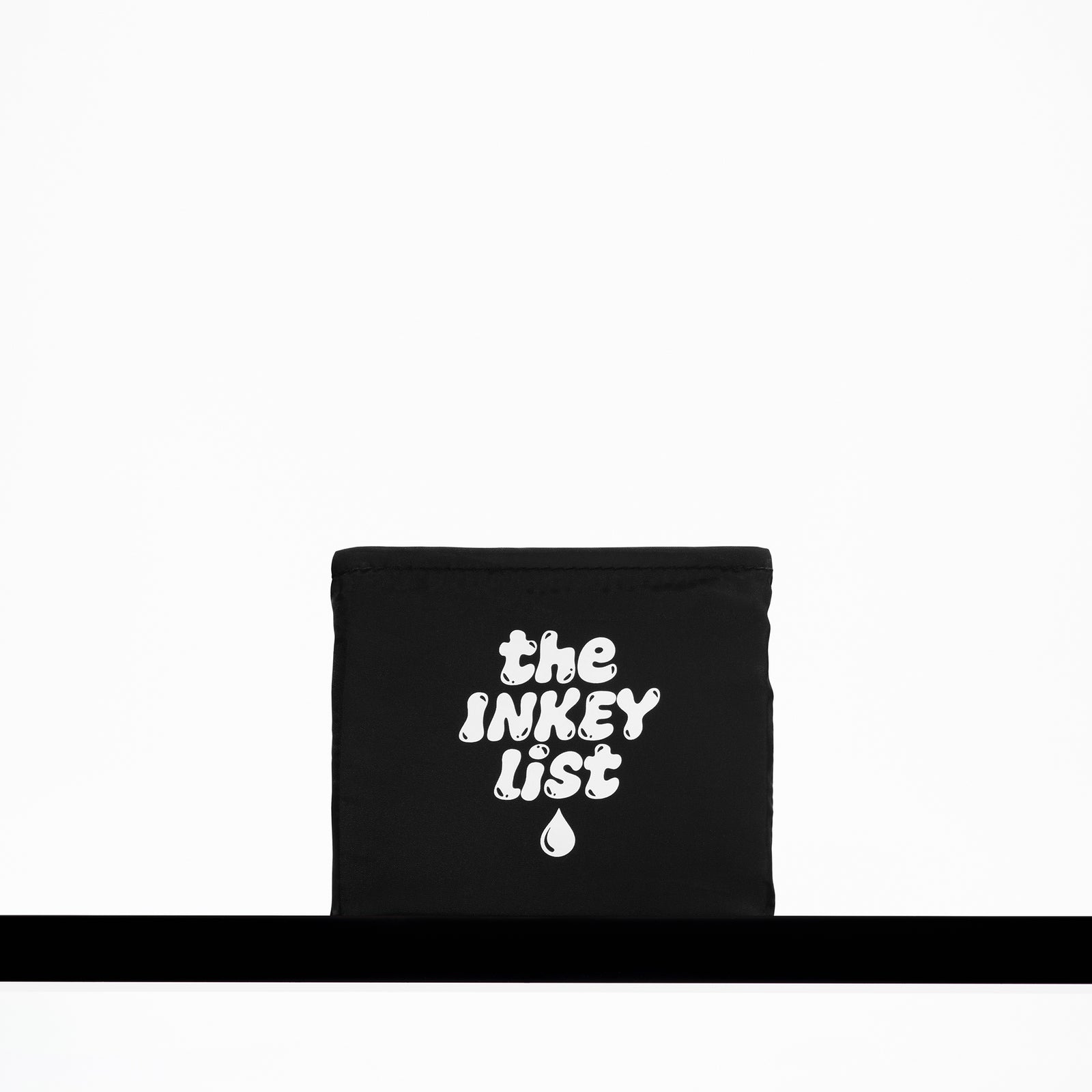 Black pouch with 'the INKEY list' text on a white background