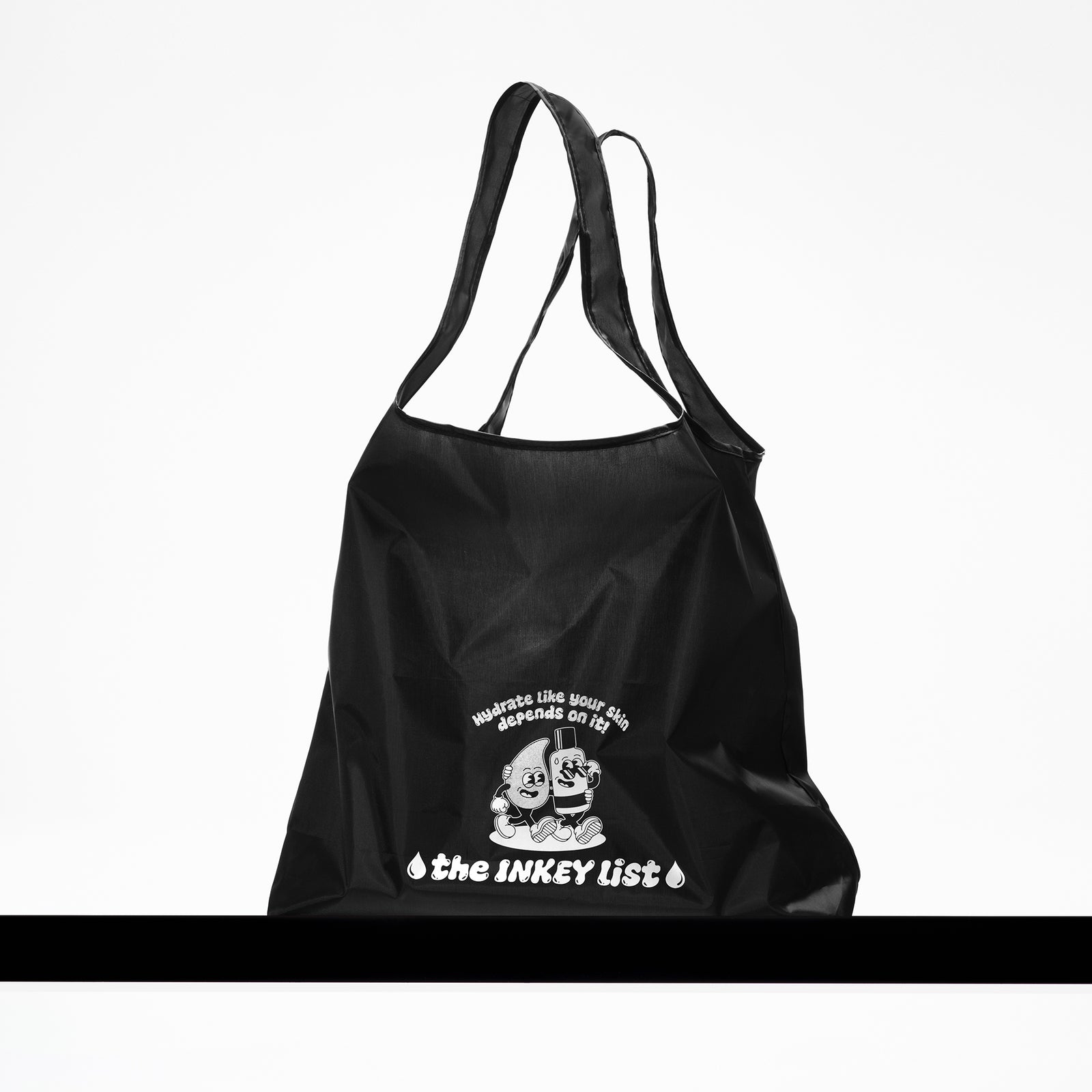 Black tote bag with 'the INKEY list' graphic on a white background