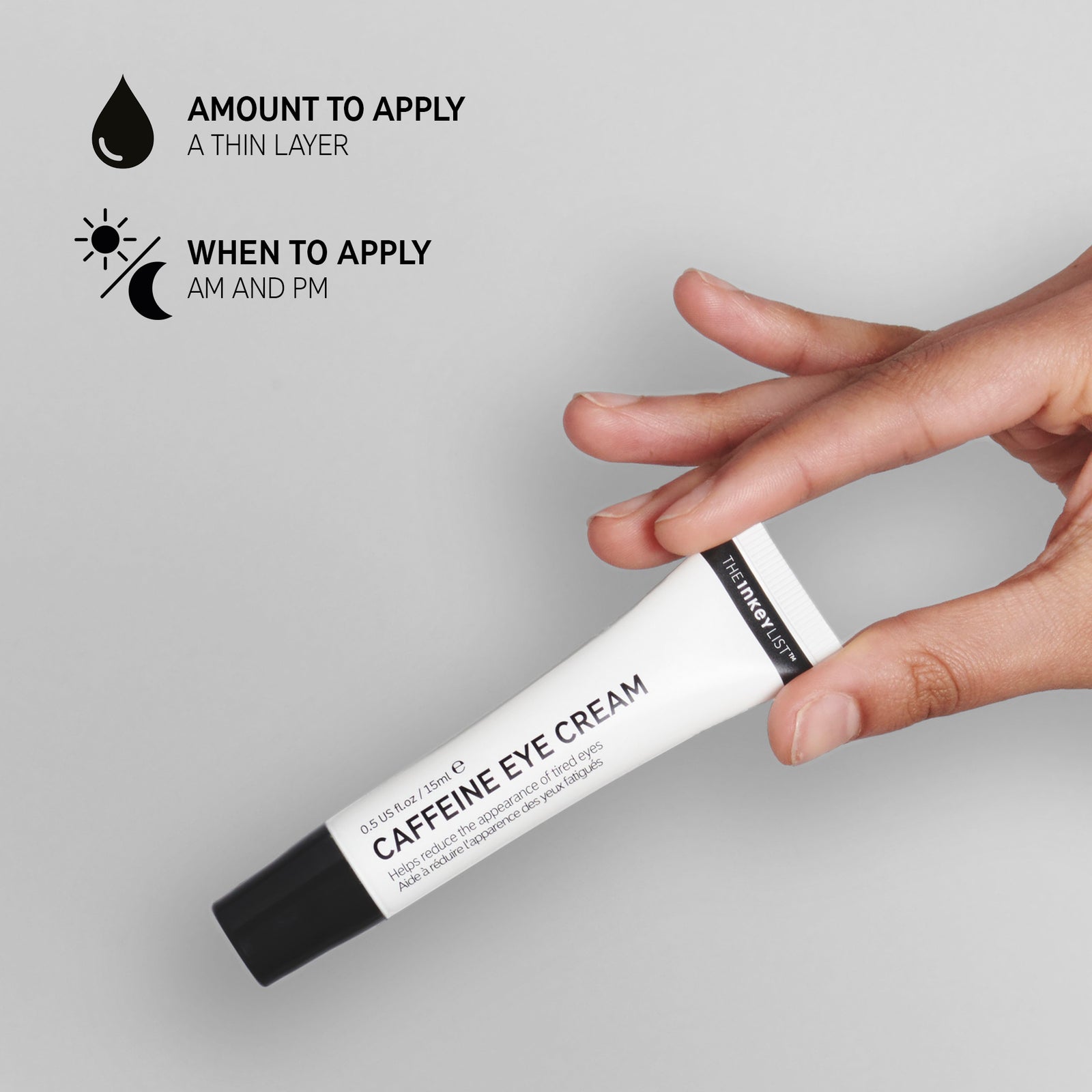 Hand holding Caffeine Eye Cream with text explaining amount to apply (a pea sized amount) and when to apply (AM and PM)