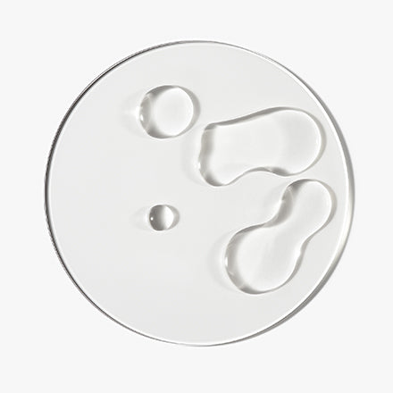 Caffeine stimulating scalp treatment texture shot on glass 